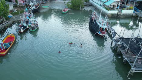 children swimming at an estuarine river at bang pu fishing village, sam roi yot national park, prachuap khiri khan, thailand