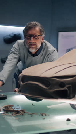 senior designer working on a clay car model