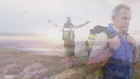 Composite-of-caucasian-senior-man-hiking,-and-standing-on-mountainside-with-arms-outstretched