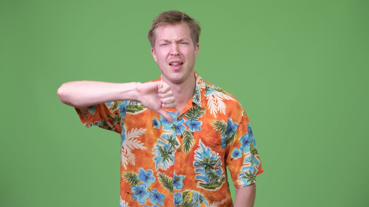 Young sad tourist man giving thumbs down