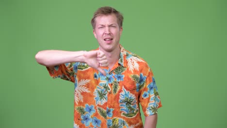 young sad tourist man giving thumbs down