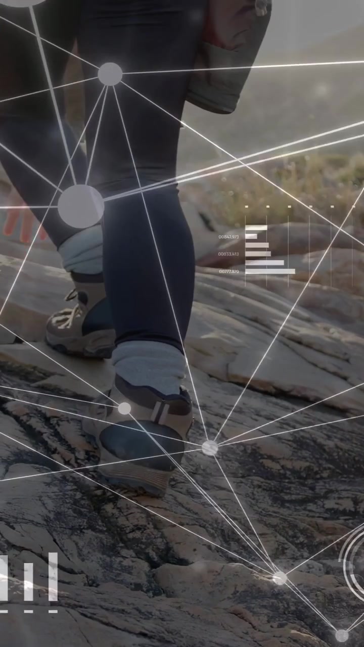 Vertical video: woman hiking stepping on rock causing HUD showing metrics for tech while ascending
