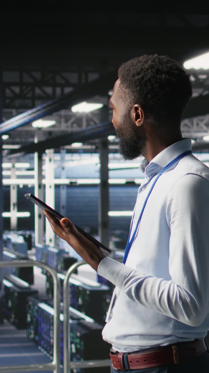 Vertical video Software developers on data center industrial platform analyzing performance