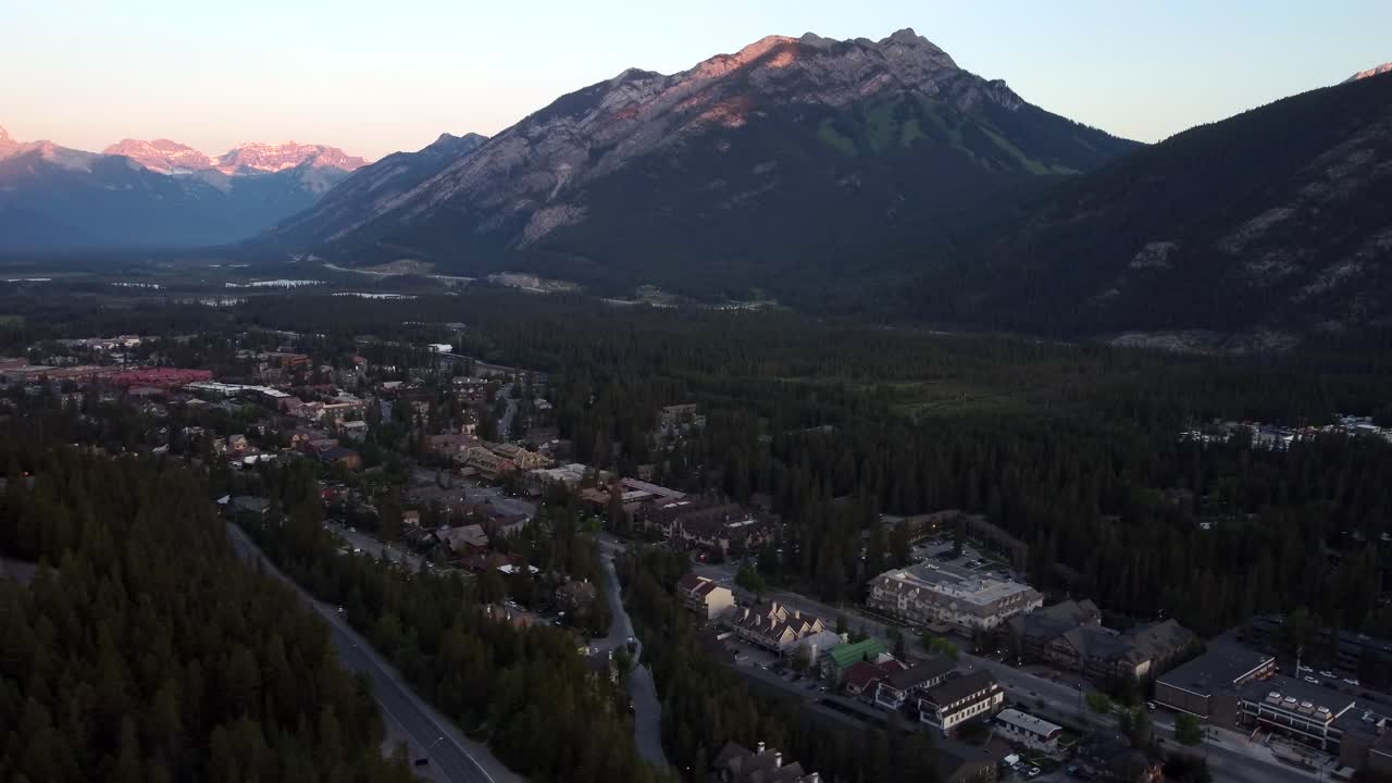 Aerial View of a Mountain Town in a Forested Valley at Sunrise
