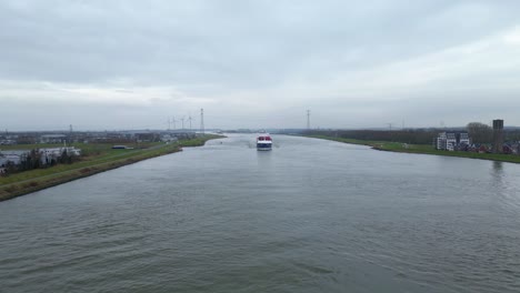 Aerial-Flying-Over-Oude-Maas-Towards-Approaching-Cargo-Ship-In-The-Distance-In-Dordrecht