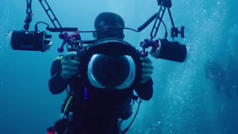 Scuba Divers with Underwater Camera Equipment