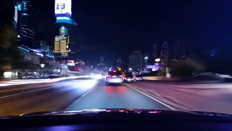 nighttime city driving scene with blurred traffic