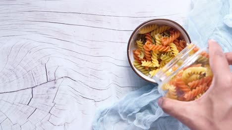 colorful spiral pasta in a bowl and jar