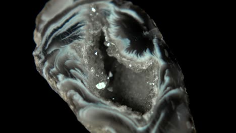 seamlessly rotating a mineral (oco agate geode) in front of black background