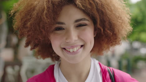 close up portrait of cute young teenage student girl smiling cheerful looking at camera lively woman trendy afro hairstyle