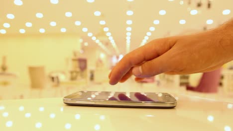 Young-Man-Using-His-Smartphone-In-A-Cafe-Close-Up-Hands-8