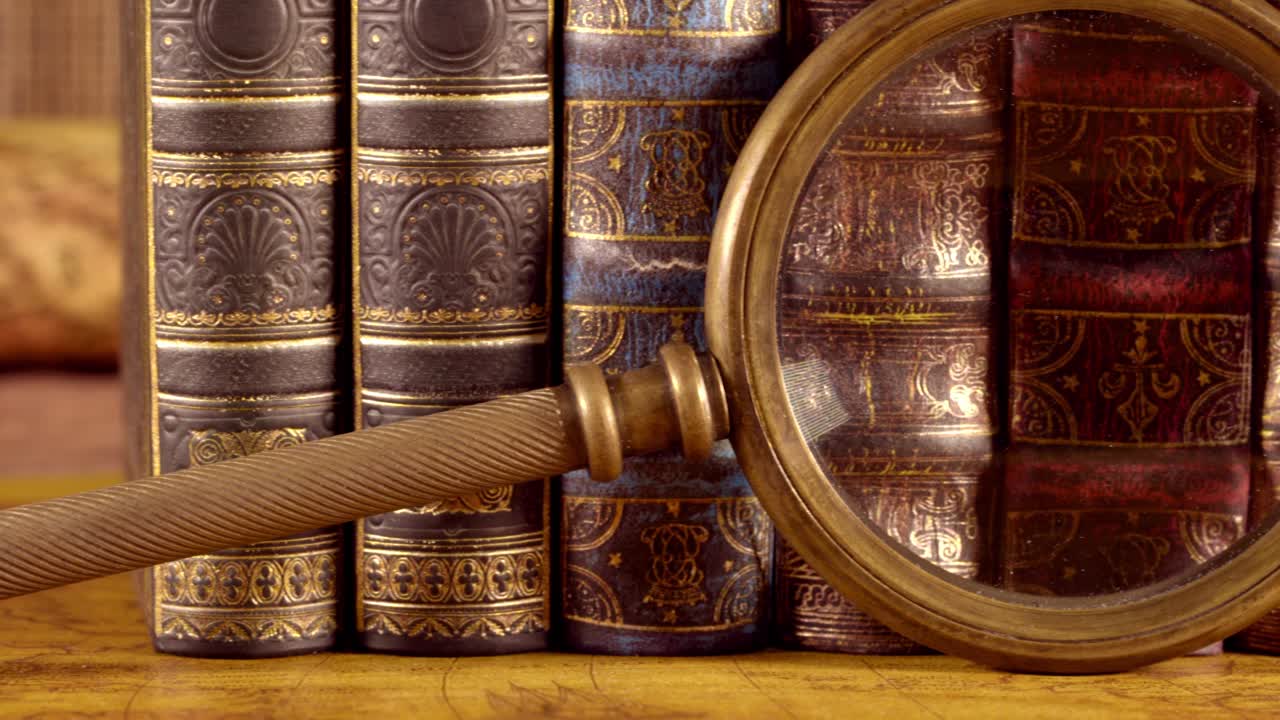 libros antiguos y lupa