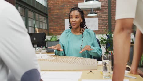 Happy-diverse-architects-looking-at-architectural-models-at-office