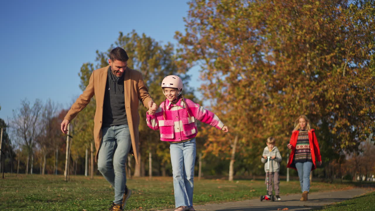 Family enjoying autumn day in park