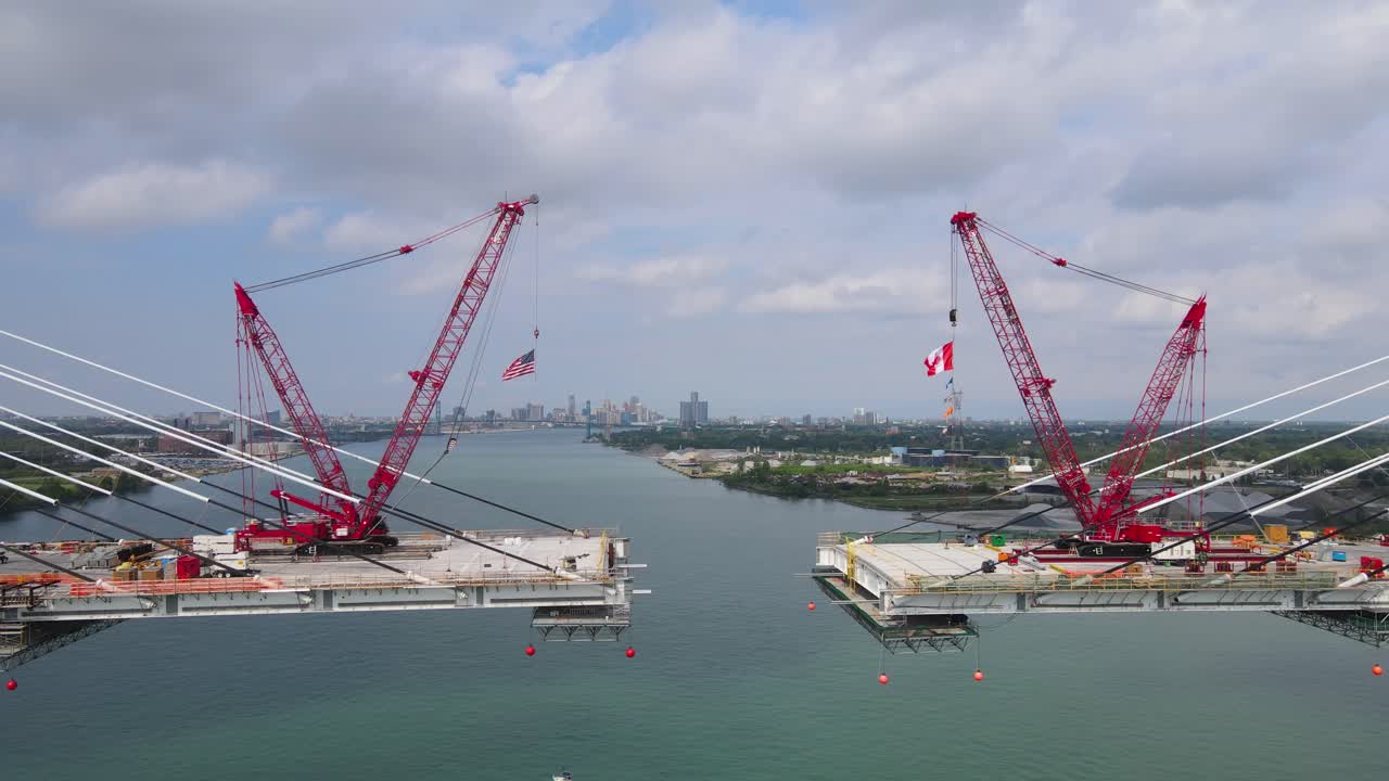 Suspension bridge construction with cranes and cables over Detroit river