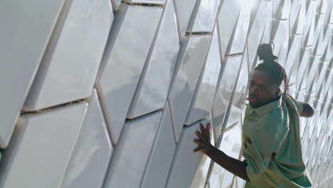 active guy moving abstract wall. dancer expressing feelings through choreography