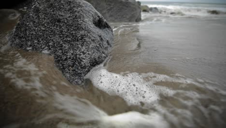 tide water rising and swirling around jetty, santa monica ca