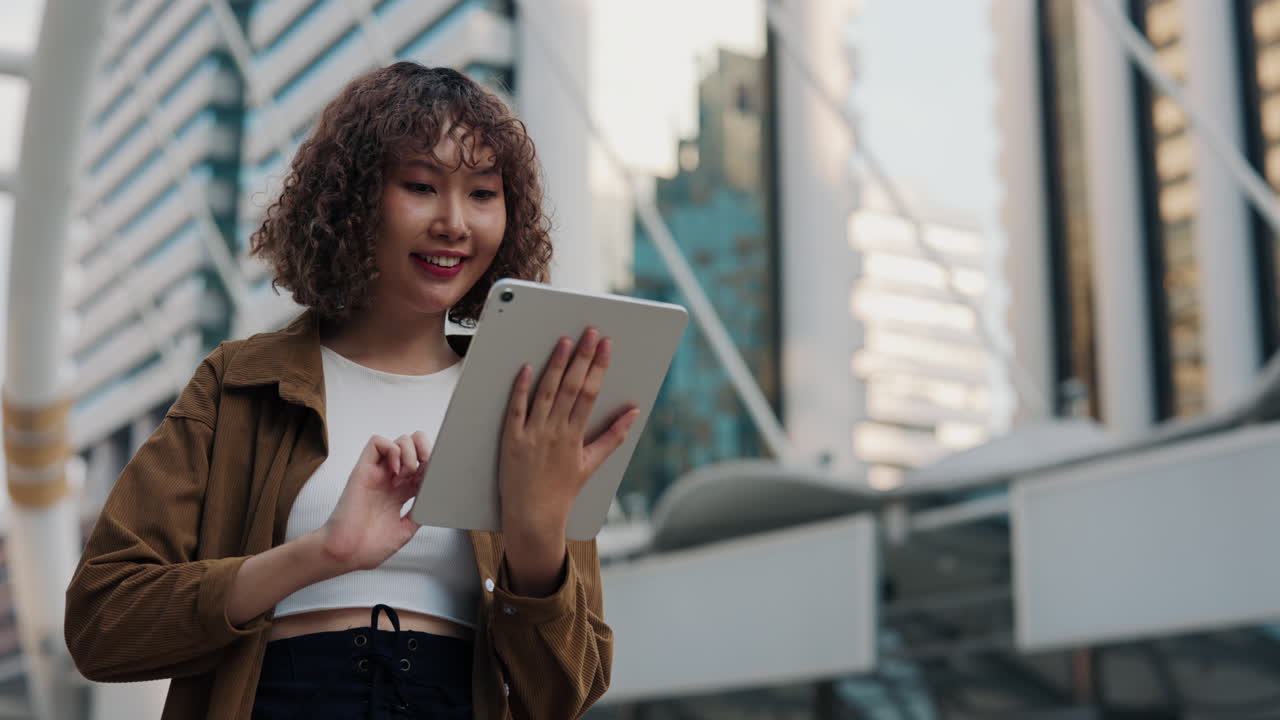 Woman using a tablet in a city