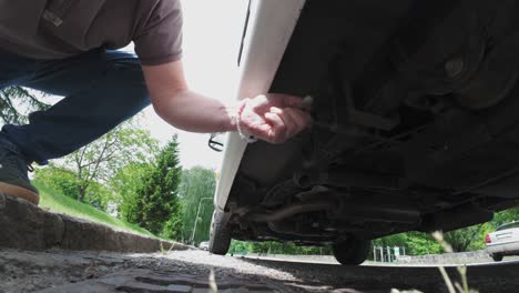 a person discharges grey water from a caravan using the handle