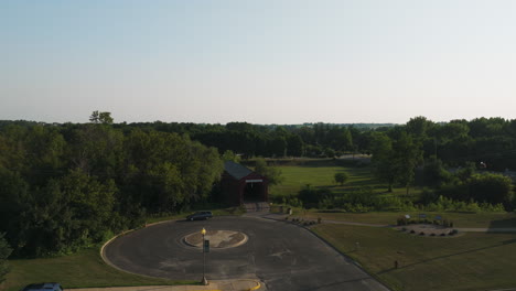Drone-aerial-shot-of-Zumbrota,-Minnesota-town-with-historic-covered-bridge