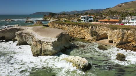 looking over a picturesque community along a rocky and rugged coastline near pismo beach in southern california - scenic aerial view