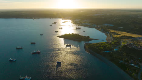 aerial hyperlapse view of sunset overlooking bay full of merchant ships, puerto montt, chile