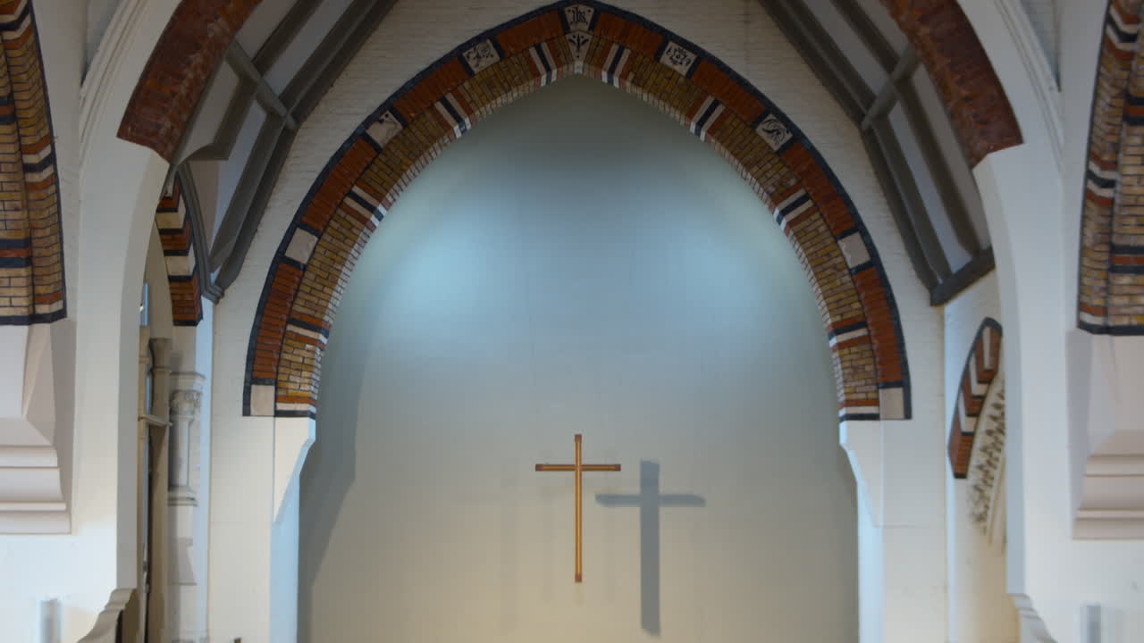 Christian Catholic Jesus crucifix cross lit up over a church altar