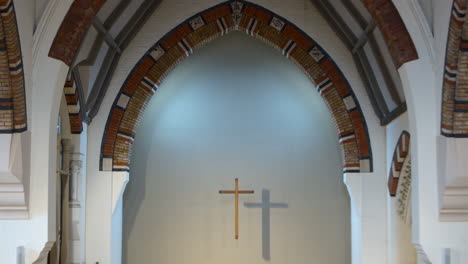 Christian Catholic Jesus crucifix cross lit up over a church altar