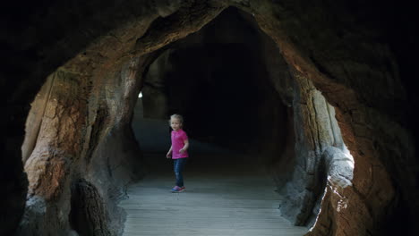 child running along the imitated cave