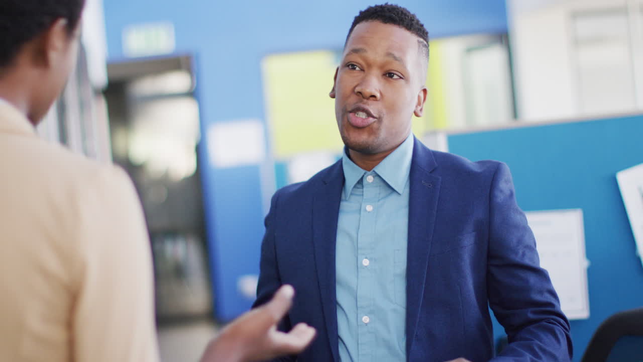 African american business people discussing work at office, slow motion