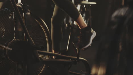 woman working out on an indoor cycling machine