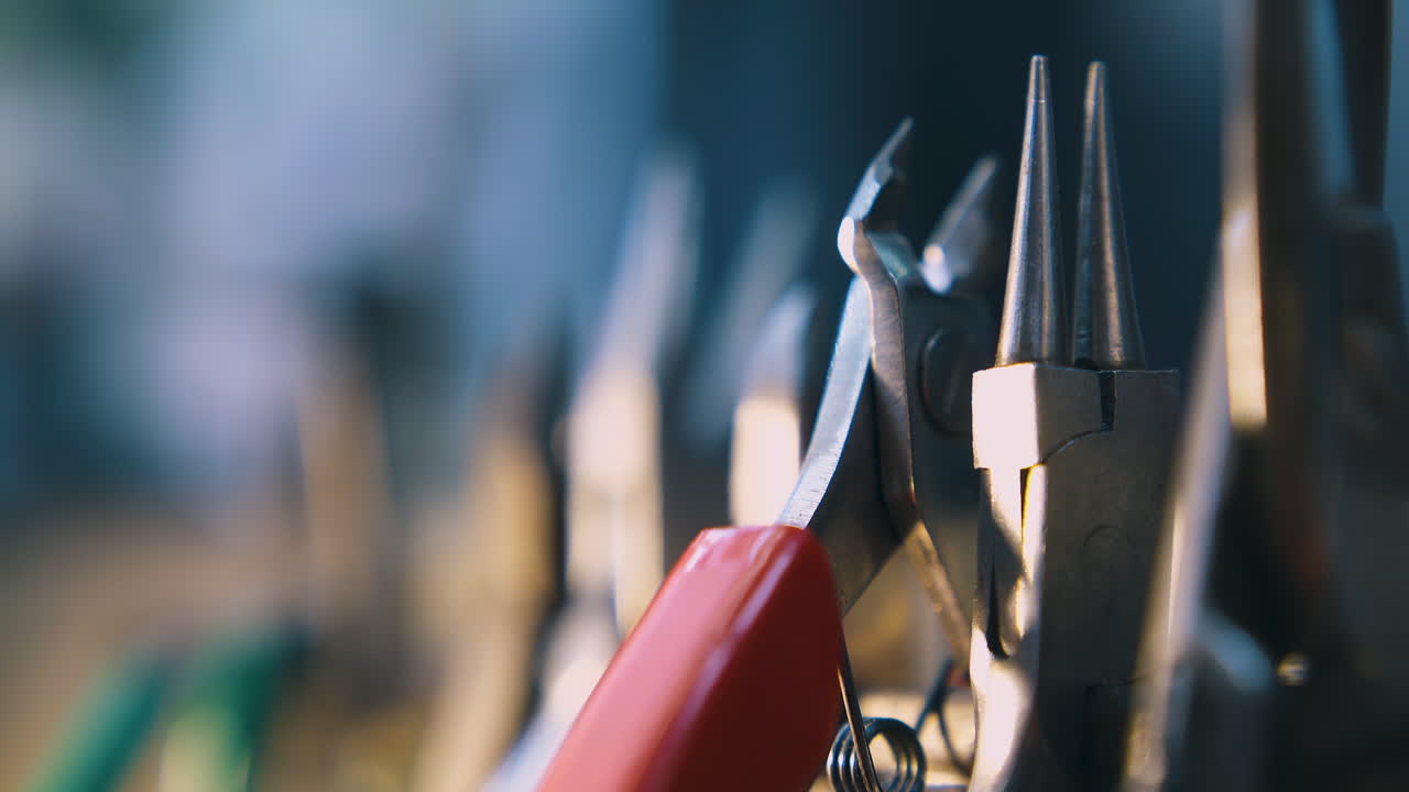 motion along goldsmith pliers at bright light close view