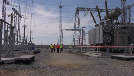 power plant workers inspecting substation equipment