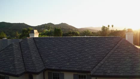 slow motion sunset reveal over house rooftop