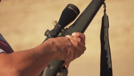Slow-Motion-Hunter-Loading-Gun-With-Scope-Close-Up-In-Desert