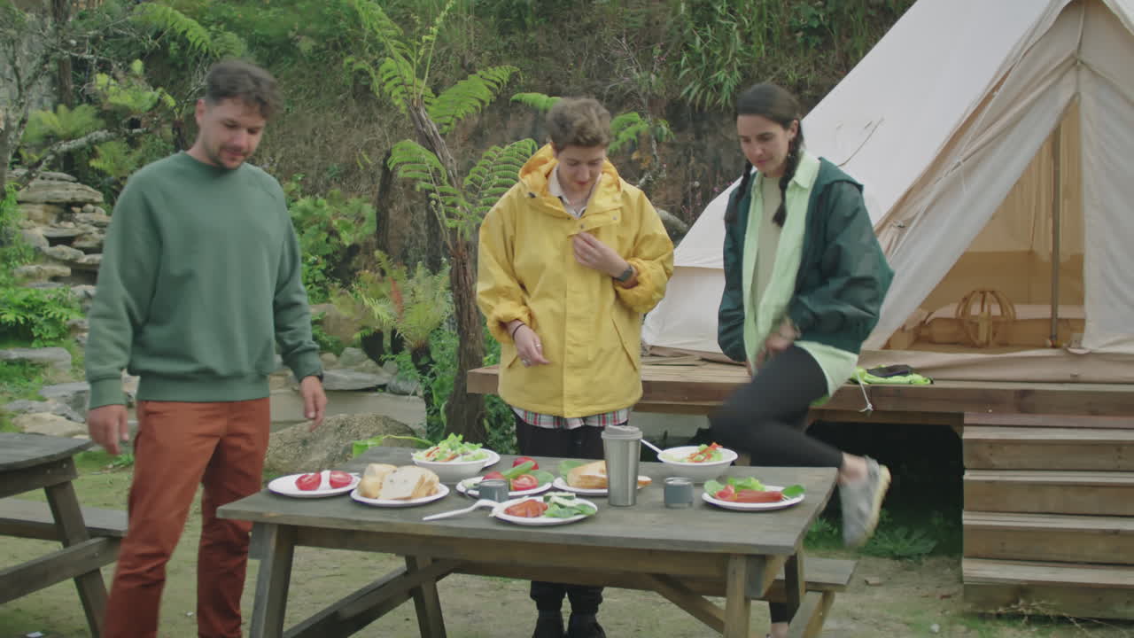 Tourists Sitting at Dinner Table at Glampsite