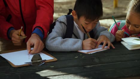 Kids-and-teacher-taking-notes-on-a-field-trip-4k