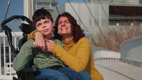 a woman and child in a wheelchair on a bridge