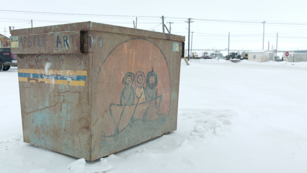 Wide shot on I&ntilde;upiat artwork on Dumpster at Utqiagvik Barrow Alaska