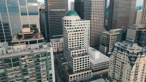 aerial ascending retreat from brown and silver modern buildings in downtown seattle