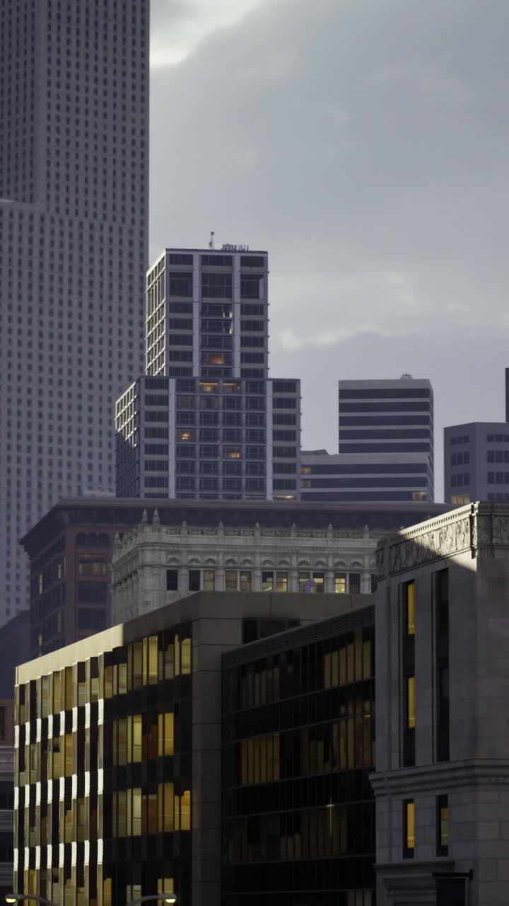 Urban skyline at dusk highlighting modern architecture and historic buildings