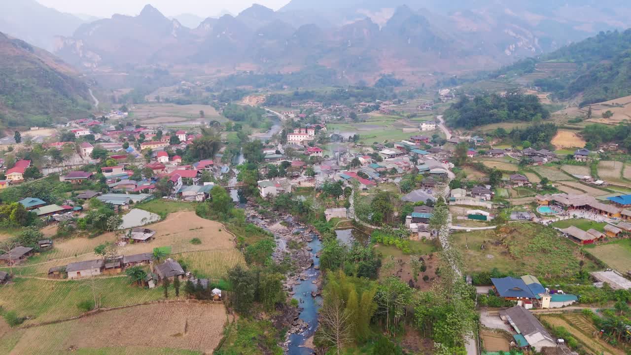 Aerial View of a Village in a Valley with a River