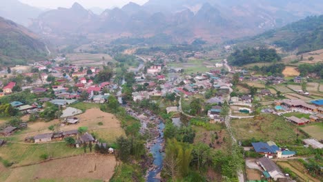 aerial view of a village in a valley with a river
