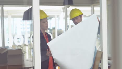 young man and woman working in a creative office