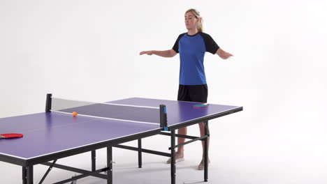 female table tennis player warming up before game of table tennis on white background, copy space