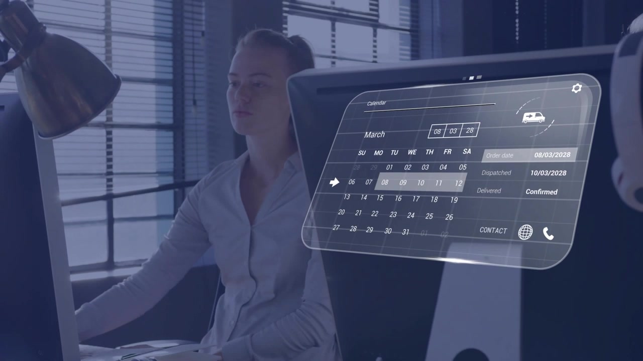 Woman at desk reaching keyboard, navigating AR calendar, updating status labels for business