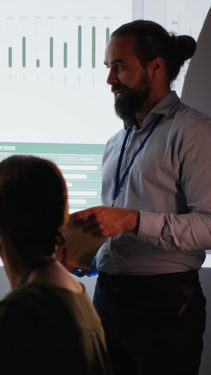 Vertical Video Multiethnic team of workers discuss the financial situation of the company