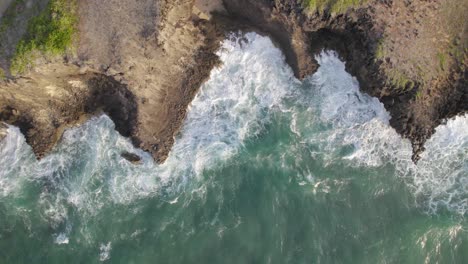 Aerial-drone-view-of-Water-waves-splashing-on-rocks,-7-Island-Kenya-Coast