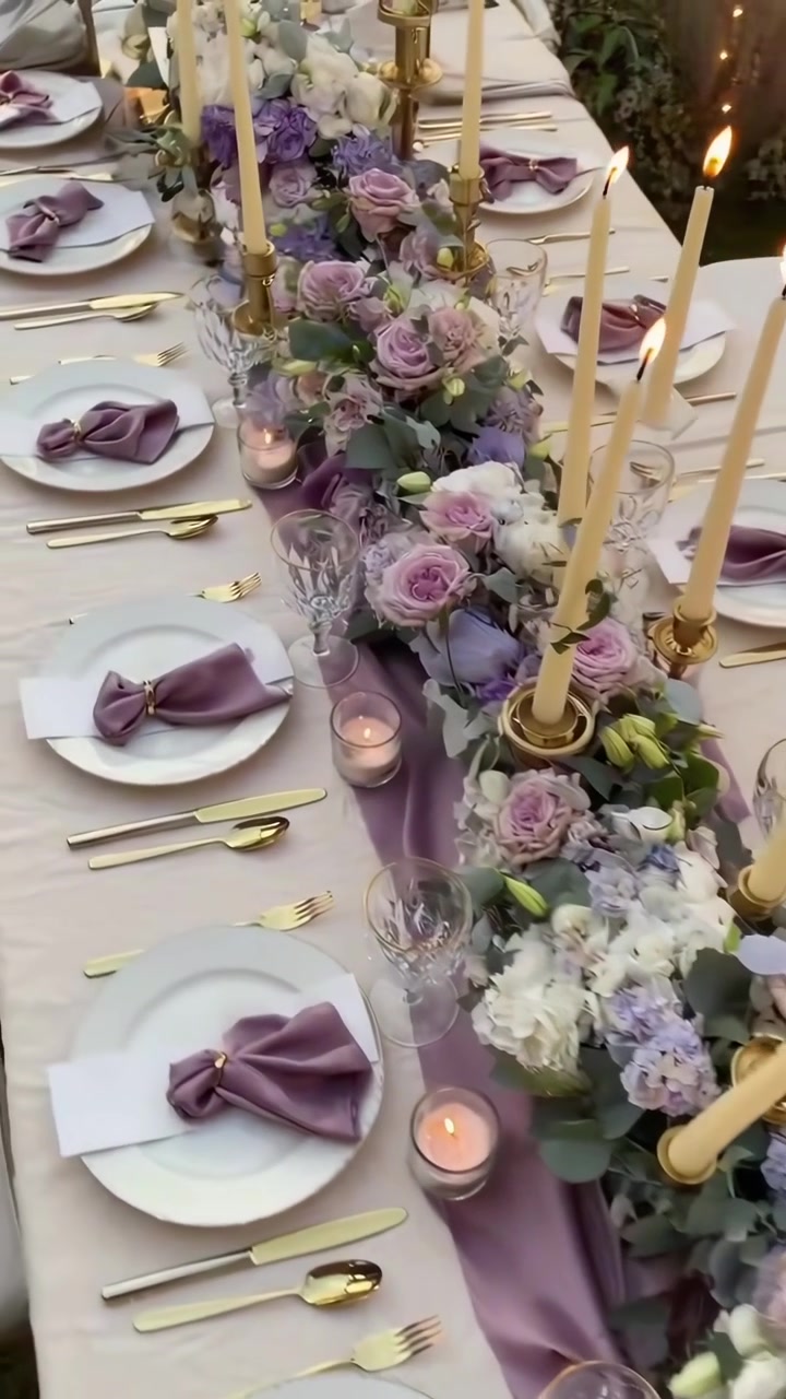Elegante tavolo da pranzo decorato con centrotavola floreale e candele accese