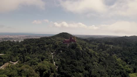 panoramic panning shot on sintra hills overlooking at historic monument pena palace and cloudscape